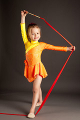 little girl doing rhythmic gymnastics with ribbon