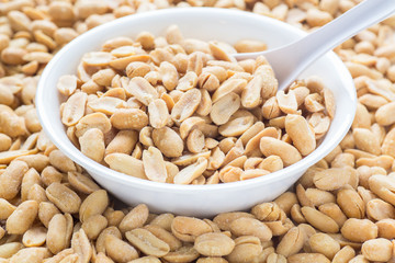 Salted Peanuts in White Bowl with Spoon