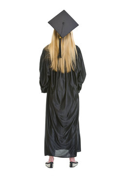 Full Length Portrait Of Woman In Graduation Gown. Rear View