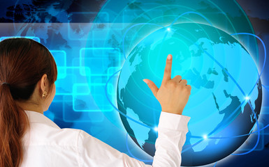 Young serious businesswoman working on modern touch screen