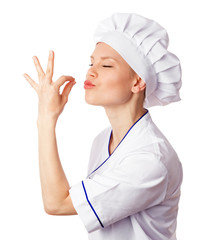 Beautiful Caucasian woman cook in uniform enjoying dish