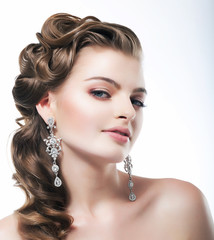 Delight. Posh Woman with Diamond Earrings. Platinum Jewelry