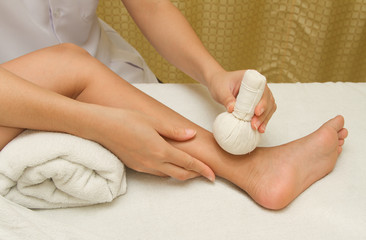 children massage with herbal compress balls