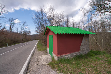 Wonderful Red and Green small house at the side of a Campaign Ro