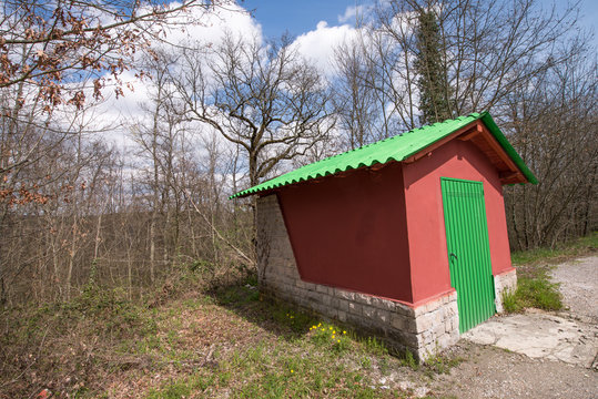 Wonderful Red and Green small house at the side of a Campaign Ro