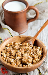 Muesli in wooden plate and milk