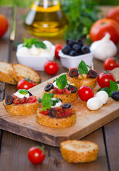 Bruschetta with mozzarella on chopping board