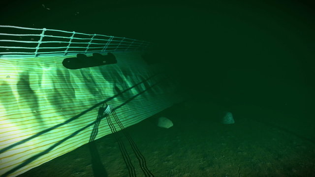 Camera under water filming a shipwreck