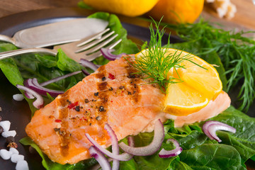 grilled salmon fillets on spinach