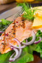 grilled salmon fillets on spinach