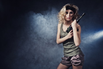 Military girl wearing a sexy outfit with a gun in his hand