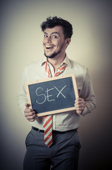 businessman with a blank blackboard write sex