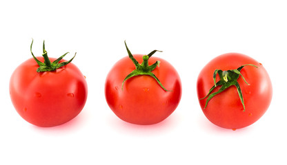 Three fresh tomatos covered with water drops isolated
