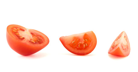 Fresh red tomato cut into pieces, isolated