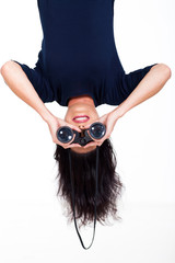 upside down woman holding binoculars