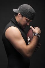 Young Muscles man in studio with ball on black background