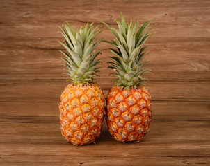 two Pineapples on wooden grunge background