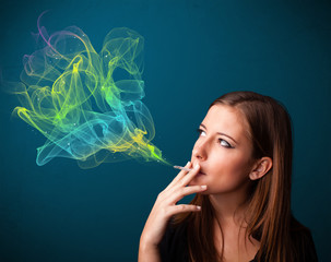 Fototapeta premium Pretty lady smoking cigarette with colorful smoke