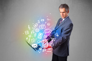 Businessman holding notebook with colorful hand drawn multimedia