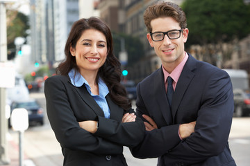 Portrait Of Businessman And Businesswoman Outside Office