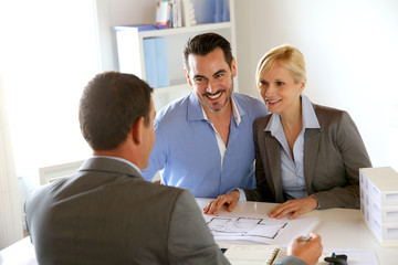 Couple meeting real-estate agent to buy property