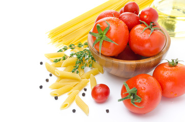 fresh tomatoes, penne pasta, spaghetti and spices on white