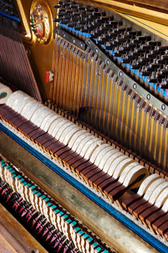 Inside an Upright Piano. Felt Hammers used to strike Steel