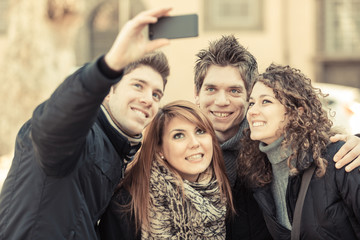Group of Friends taking Self Portraits with Mobile Phone