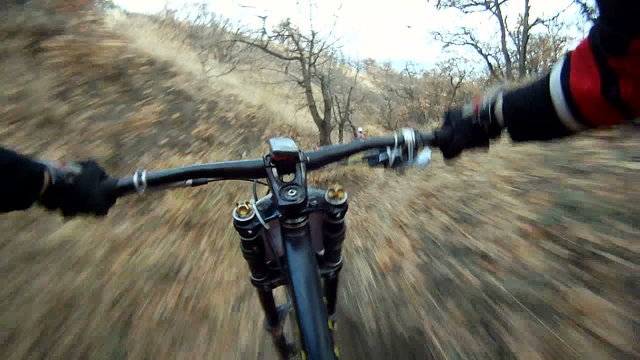 Cyclist riding down a difficult track