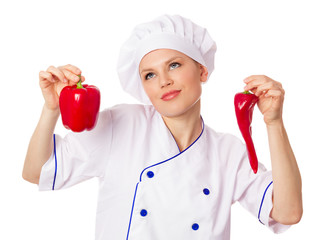 Attractive female cook in uniform holding red peppers, confused