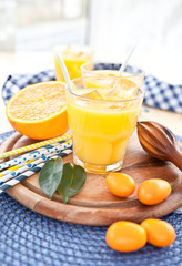 Fototapeta premium Fresh juice from oranges and kumquats