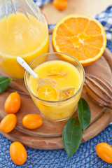 Fototapeta na wymiar Fresh juice from oranges and kumquats