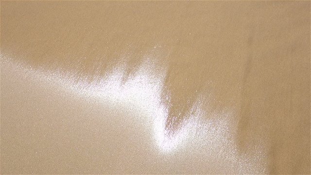 Sand - drying fast after wave - detail view