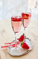 Two glasses of champagne with strawberries