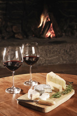 Two Glasses Of Red Wine At A Cosy Fireplace