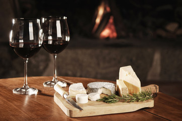 Two Glasses Of Red Wine At A Cosy Fireplace