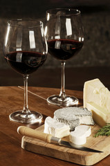 Two Glasses Of Red Wine And Cheese