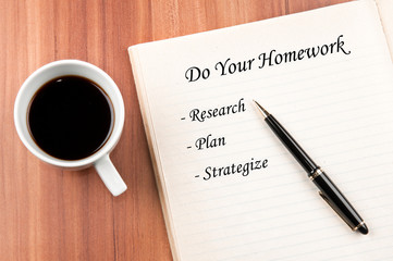 Notebook and coffee over a wooden table
