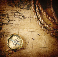 old compass and rope on vintage map 1732