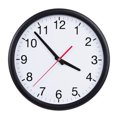 Office clock shows five minutes to four