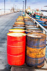 Old oil barrels placed on bridge ports in the sea