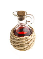 Small decanter with red wine vinegar isolated on the white