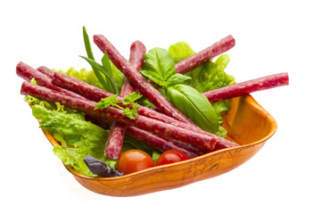 Ripe salami with salad, basil, onion and tomato