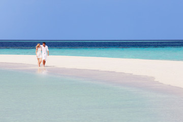 Romantic Couple Walking On Beautiful Tropical Beach