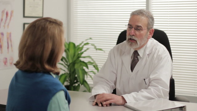 Doctor speaking with female patient in office