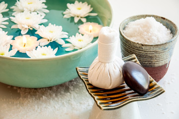 Spa still life with exfoliation salt scrub and herbal massage ba