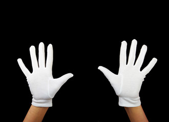 hands are showing ten fingers against black background