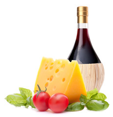 Red wine bottle, cheese and tomato still life
