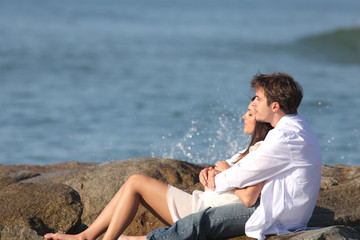 Couple embracing and watching the sea