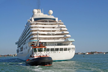 giant cruise ship for the transportation of passengers pulled by